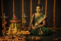 Portrait of Indian Woman celebrating Diwali festival by Lighting the lamp