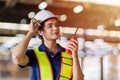 Portrait Indian woman worker supervisor with engineer safety suit work in large factory warehouse Royalty Free Stock Photo