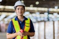 Portrait Indian woman worker supervisor with engineer safety suit work in large factory warehouse Royalty Free Stock Photo