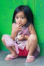 Portrait of indonesian child on green wall