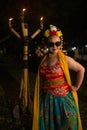 a portrait of an Indonesian dancer with jasmine dangling in her hair adorns her beautiful appearance on stage