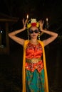 a portrait of an Indonesian dancer with jasmine dangling in her hair adorns her beautiful appearance on stage