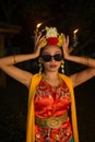 a portrait of an Indonesian dancer with jasmine dangling in her hair adorns her beautiful appearance on stage