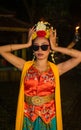 a portrait of an Indonesian dancer with jasmine dangling in her hair adorns her beautiful appearance on stage