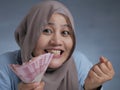 Indonesian Muslim Woman Holding Rupiah Money Royalty Free Stock Photo