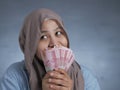 Indonesian Muslim Woman Holding Rupiah Money Royalty Free Stock Photo