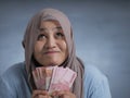 Indonesian Muslim Woman Holding Rupiah Money Royalty Free Stock Photo