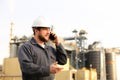 Portrait of industrial director talking by VHF walkie talkie near factory outside.