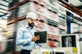 A portrait of an industrial man engineer with clipboard in a factory, working.