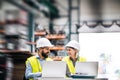 A portrait of an industrial man and woman engineer with laptop in a factory, working. Royalty Free Stock Photo