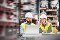 A portrait of an industrial man and woman engineer with laptop in a factory, working. Royalty Free Stock Photo