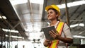 Portrait of industrial worker standing with tablet holding in her hand feeling proud and confident looking for the new opportunity