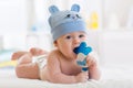 Portrait of infant baby boy playing with teething toy Royalty Free Stock Photo