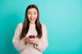 Portrait of inpressed funky teen blogger use her cell phone got news from social account wear knitted woolen jumper Royalty Free Stock Photo