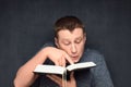 Portrait of inquisitive man reading big book Royalty Free Stock Photo