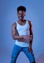 Attractive yong african american man dancing and having fun in moody disco light