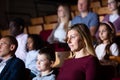 Interested woman theatergoer watching stage performance in theater