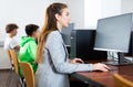 Interested young woman studying in university computer lab Royalty Free Stock Photo