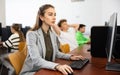 Interested young woman studying in university computer lab Royalty Free Stock Photo