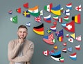 Portrait of interpreter and flags of different countries on grey background