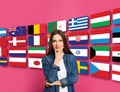 Portrait of interpreter and flags of different countries on pink background