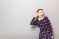 Portrait of intrigued girl placing hand near ear and eavesdropping