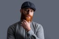 Portrait of Irish guy. Serious guy stroking red beard. Bearded guy with unshaven face Royalty Free Stock Photo