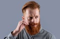 Portrait of Irish man twirling mustache. Bearded man with unshaven face. Serious man with red beard Royalty Free Stock Photo