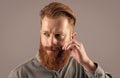 Portrait of Irish man twirling mustache. Bearded man with unshaven face. Serious man with red beard Royalty Free Stock Photo