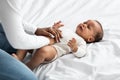 Black mother doing belly massage for crying infant Royalty Free Stock Photo