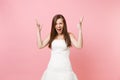 Portrait of irritated angry bride woman in beautiful white wedding dress stand screaming spreading hands isolated on