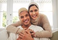 Portrait, Islam and happy couple hug on couch with smile, culture and love in home in Turkey. Face of Muslim man, woman