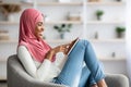 Portrait Of Islamic Black Lady In Hijab Using Digital Tablet At Home Royalty Free Stock Photo