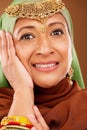 Portrait, Islamic woman and fashion with jewelry, smile and natural beauty on brown studio background. Muslim female