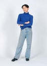 Portrait isolated cutout studio full body shot of Asian young gay male model in turtleneck longsleeve shirt denim jeans with high Royalty Free Stock Photo