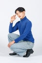 Portrait isolated cutout studio full body shot Asian young sexy slim fashionable LGBTQ gay male fashion model in turtleneck long Royalty Free Stock Photo