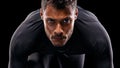 Portrait, isolated runner and man ready to run, start race and intense focus in dark studio background. Serious, man and