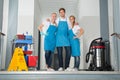 Portrait Of Janitors Holding Cleaning Equipments Royalty Free Stock Photo