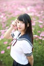 Portrait of Japanese school girl uniform with pink cosmos flower Royalty Free Stock Photo