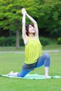 Portrait of Japanewe woman doing yoga  warrior I pose Royalty Free Stock Photo