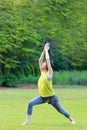 Portrait of Japanewe woman doing yoga  warrior I pose Royalty Free Stock Photo