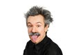 Portrait of jocular aging man with grey long hair sticking his tongue out in Einstein manner. Isolated on background Royalty Free Stock Photo