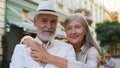 Portrait joyful aged Caucasian happy family elderly wide smiling pensioners woman hugging embrace man looking at camera Royalty Free Stock Photo