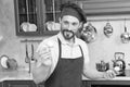 Portrait of joyful bearded cook with mushroom in hand