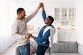 Portrait of joyful black man and woman dancing at home Royalty Free Stock Photo
