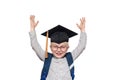 Portrait of a joyful blond boy in big glasses, academic hat and a school bag. Hands up. Isolate Royalty Free Stock Photo