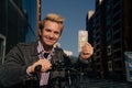 Portrait of a joyful blond guy who found banknotes. The concept of winning the lottery