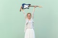 Cheerful blonde woman with eyeglasses raised her arms and holding guitar. Royalty Free Stock Photo