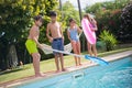 Portrait of joyful children standing on edge of swimming pool Royalty Free Stock Photo