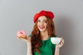 Portrait of joyful elegant lady with ginger hair in red beret ha